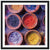Assorted natural pigments in bowls create a vibrant display.


