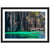 Crystal-clear water beside cliffs with a small bridge in a framed photo.

