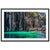 Vivid green water along dark rock cliffs in a portrait photograph.

