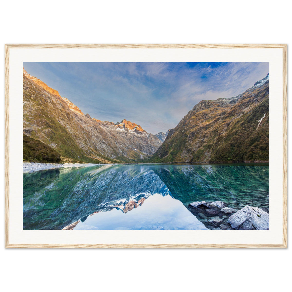 Framed scenic artwork showing serene alpine terrain and a blue highlight.

