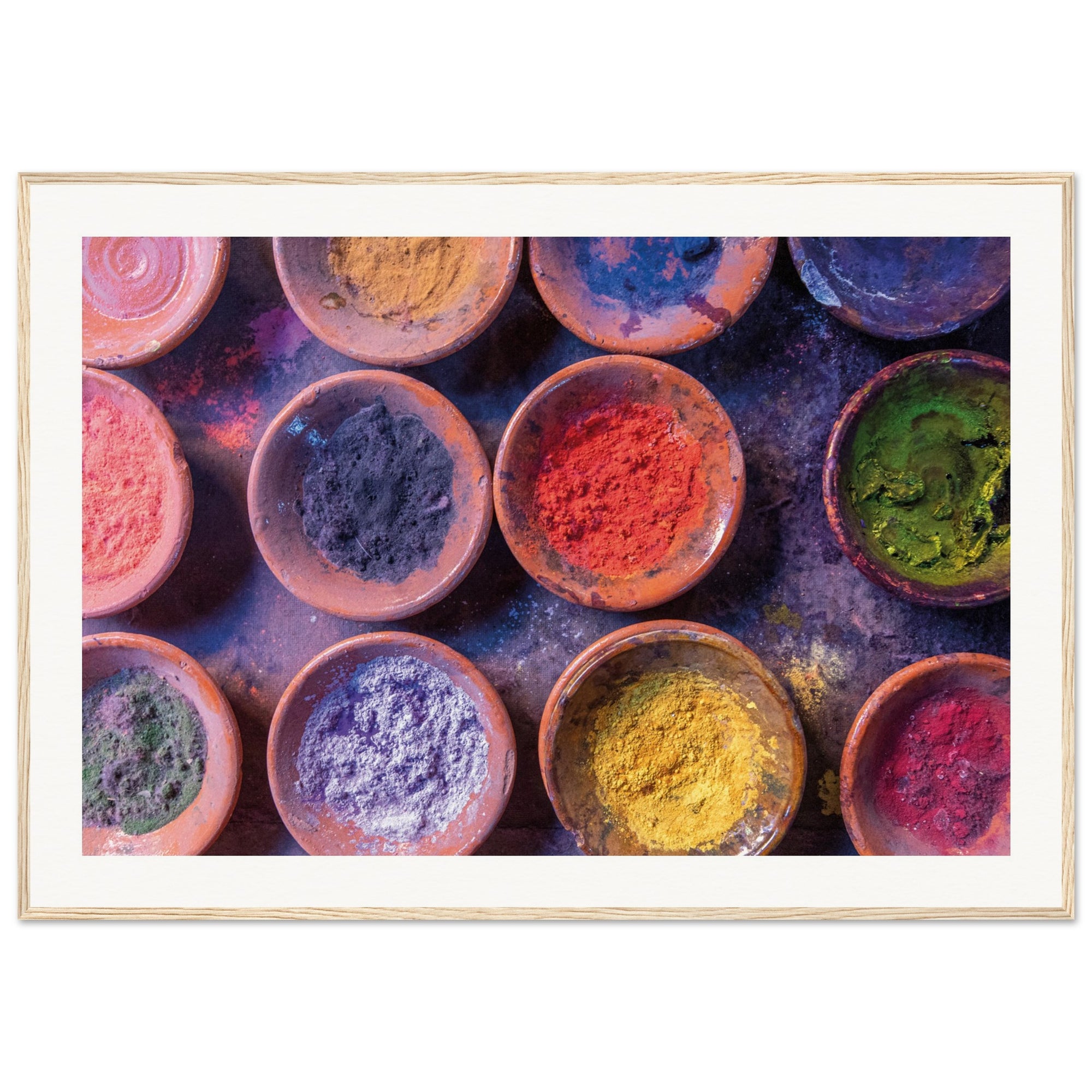 Framed image of powdered substances arranged in clay containers.


