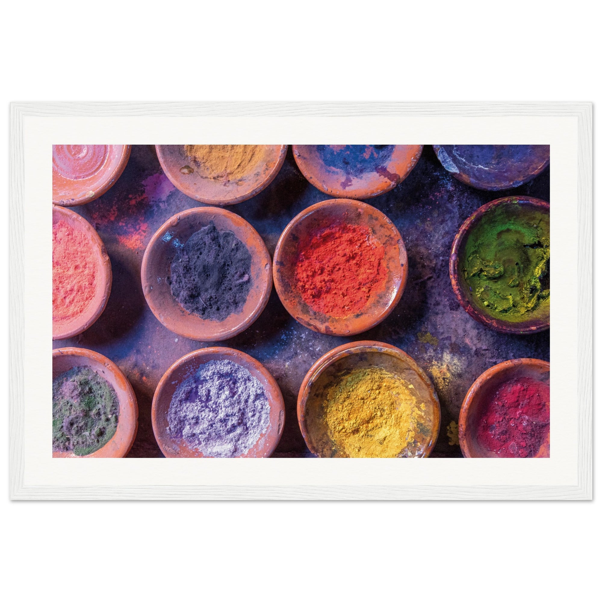 Dry pigment powders placed in circular clay dishes for framed display.

