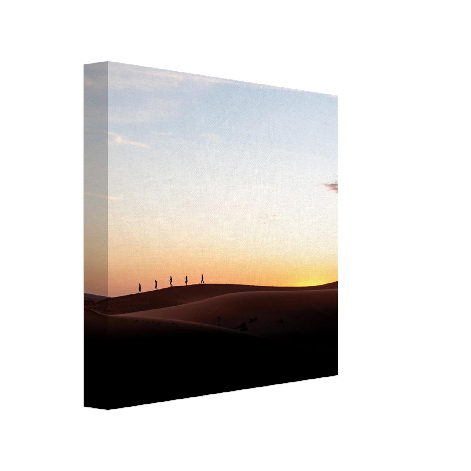 Long shadows stretch across dunes as hikers move at sunset.

