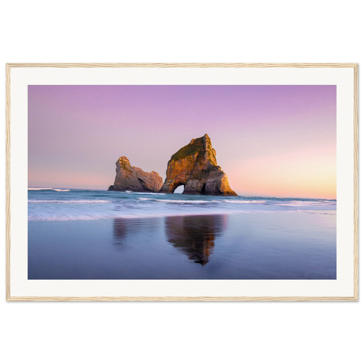 Portrait of beach and coastal rocks at sunset glow.

