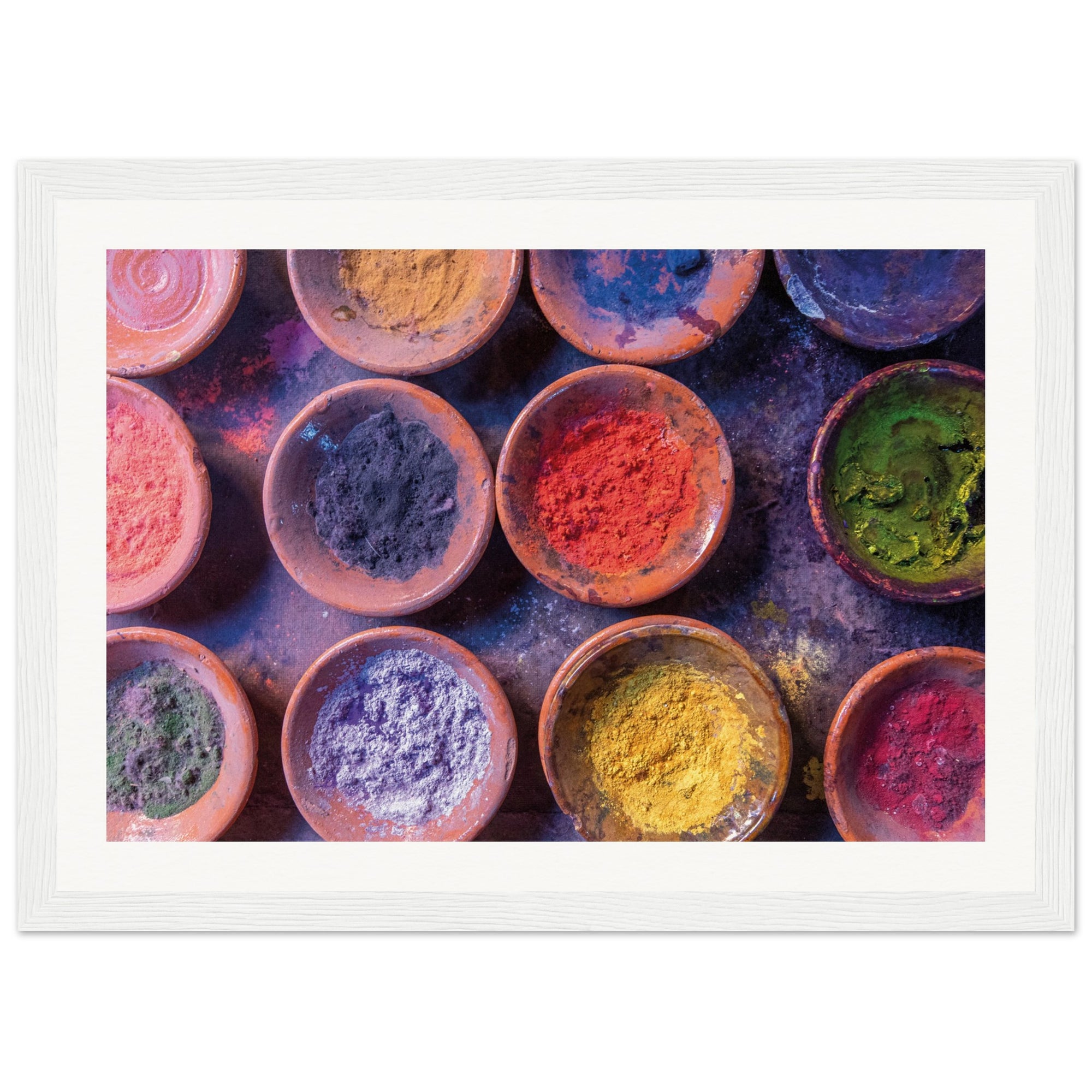 Framed photo of art materials or ceremonial colors in rustic vessels.

