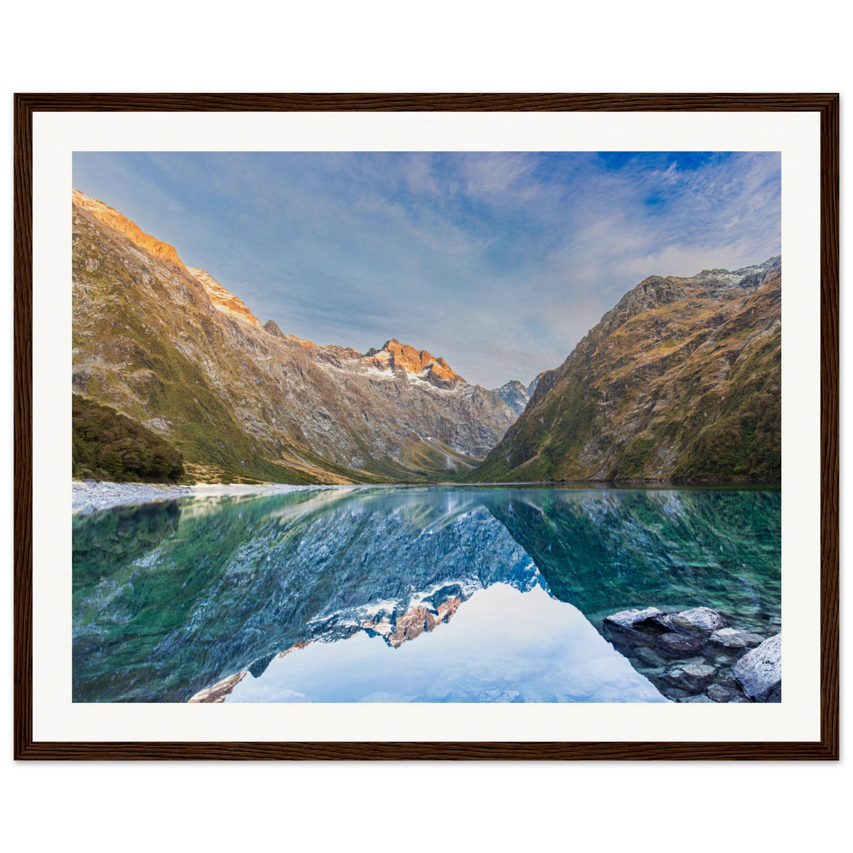 Framed mountain print with glassy lake and blue dot marker.

