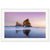 Serene ocean scene with pink sunset and rock silhouette.

