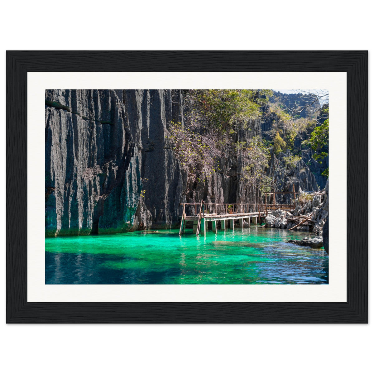 Portrait of limestone formations with a peaceful water walkway.


