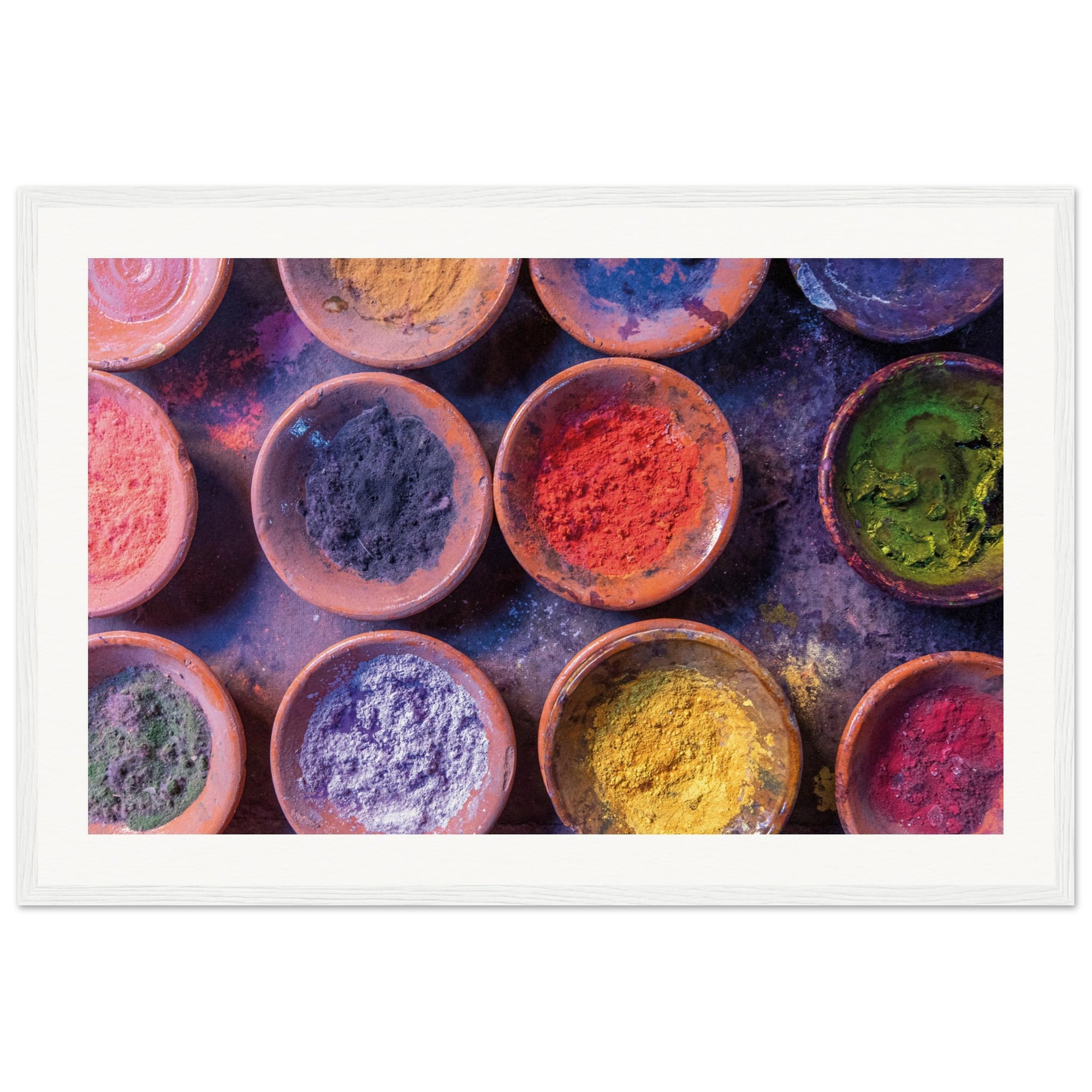 Bright color powders neatly organized in hand-crafted dishes.


