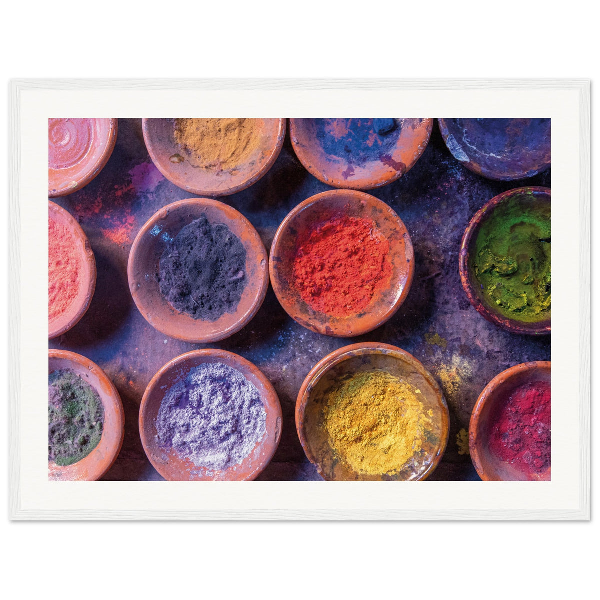 Framed artwork of color bowls used in traditional festivals.

