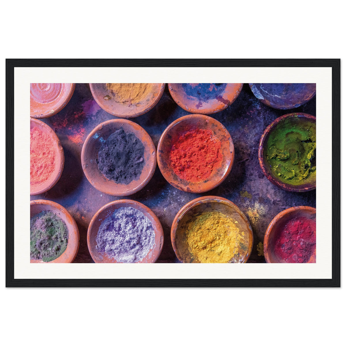 Clay bowls with powdered dyes arranged in a colorful pattern.


