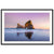 Framed beachscape featuring reflective wet sand and towering rocks.

