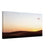 Golden desert landscape with people in silhouette.

