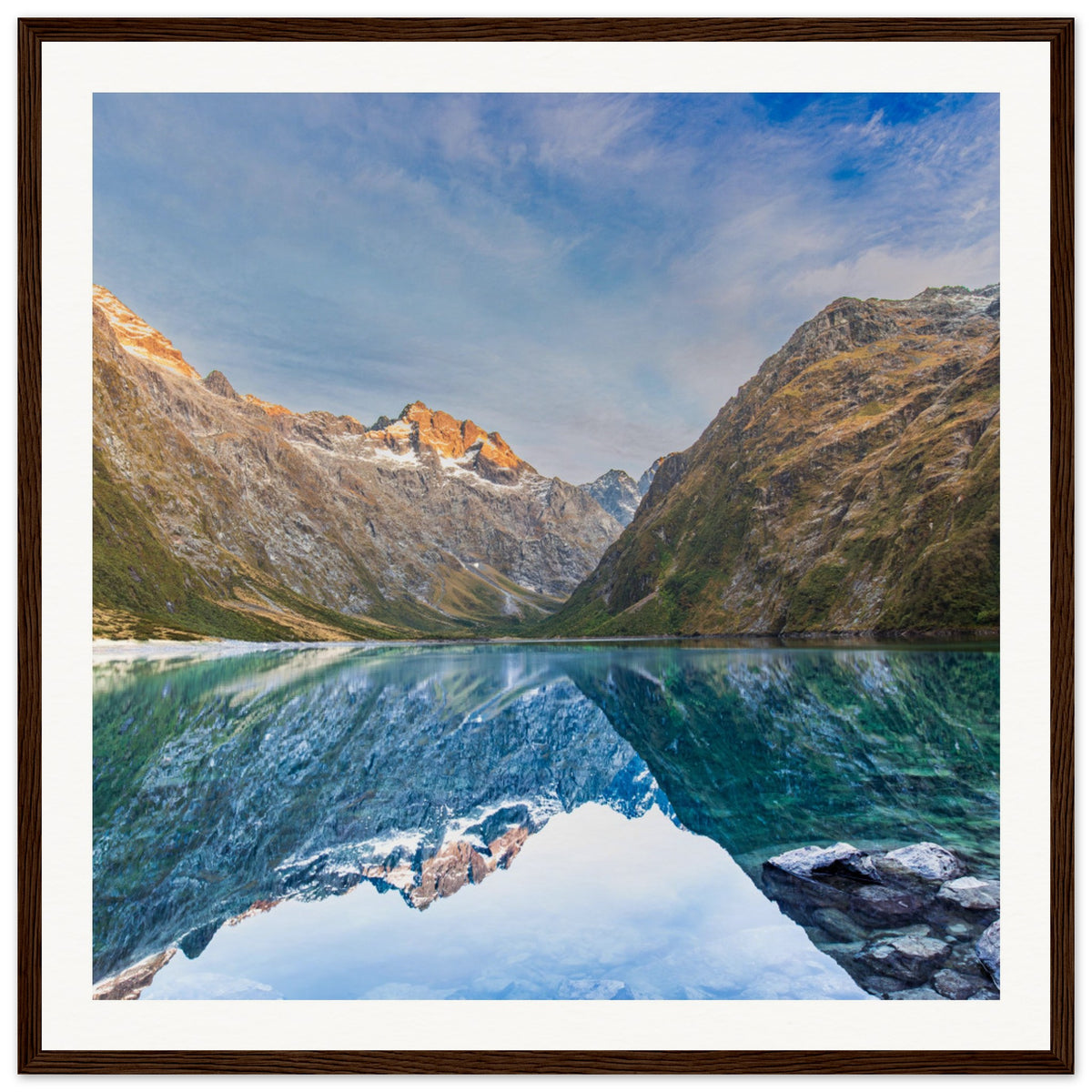 Framed mountain valley with glowing ridges and a blue dot.

