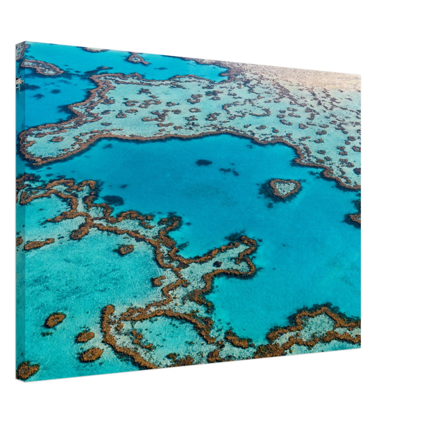 Intricate reef systems in a bright blue ocean expanse.

