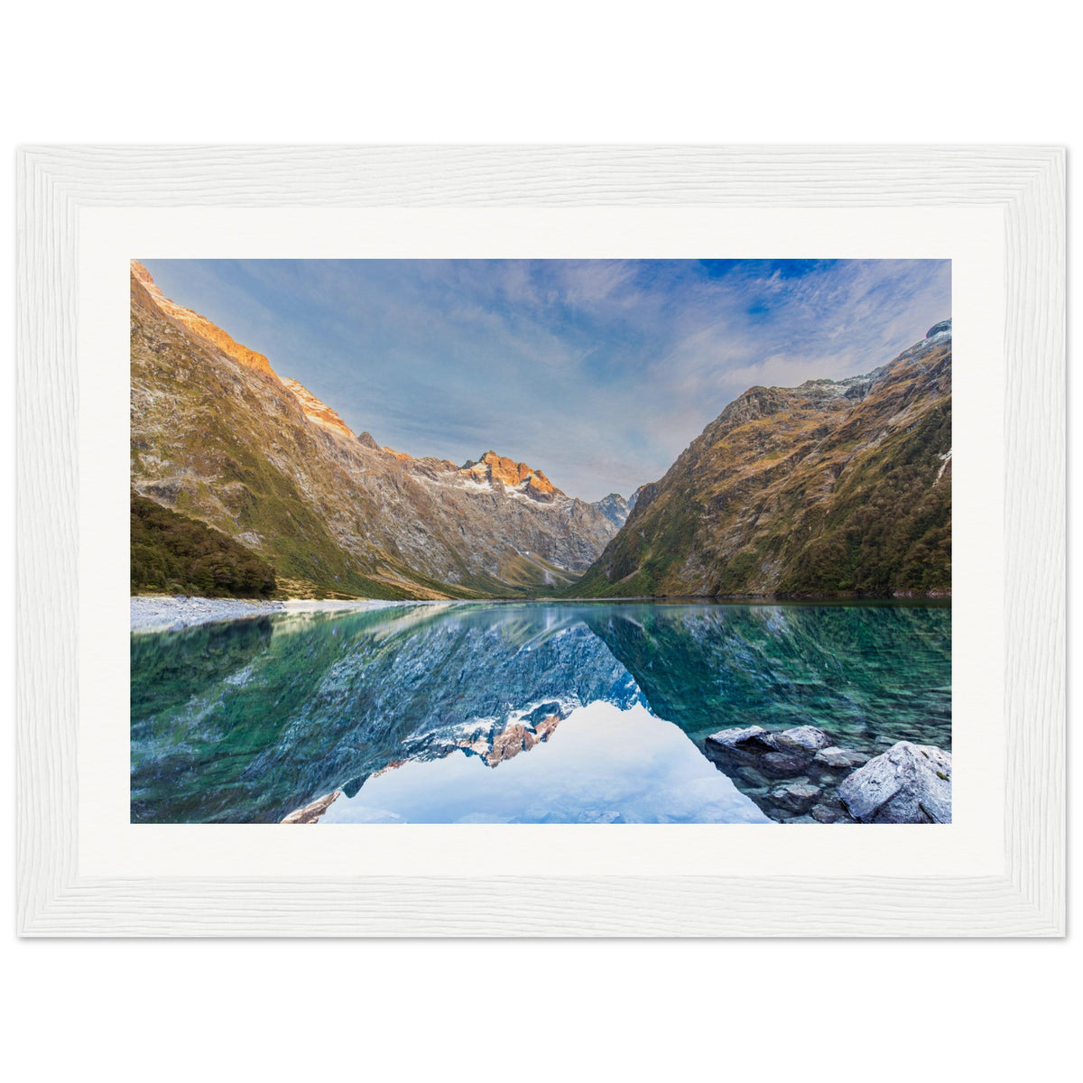 Framed vertical image of alpine view with a blue dot.

