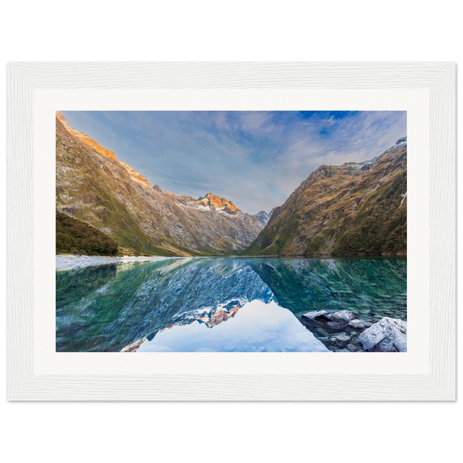 Framed vertical image of alpine view with a blue dot.

