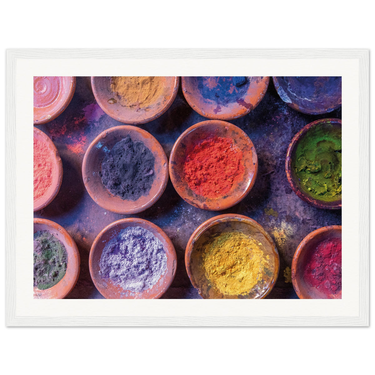 Colorful dye powders in earthenware dishes displayed as wall decor.

